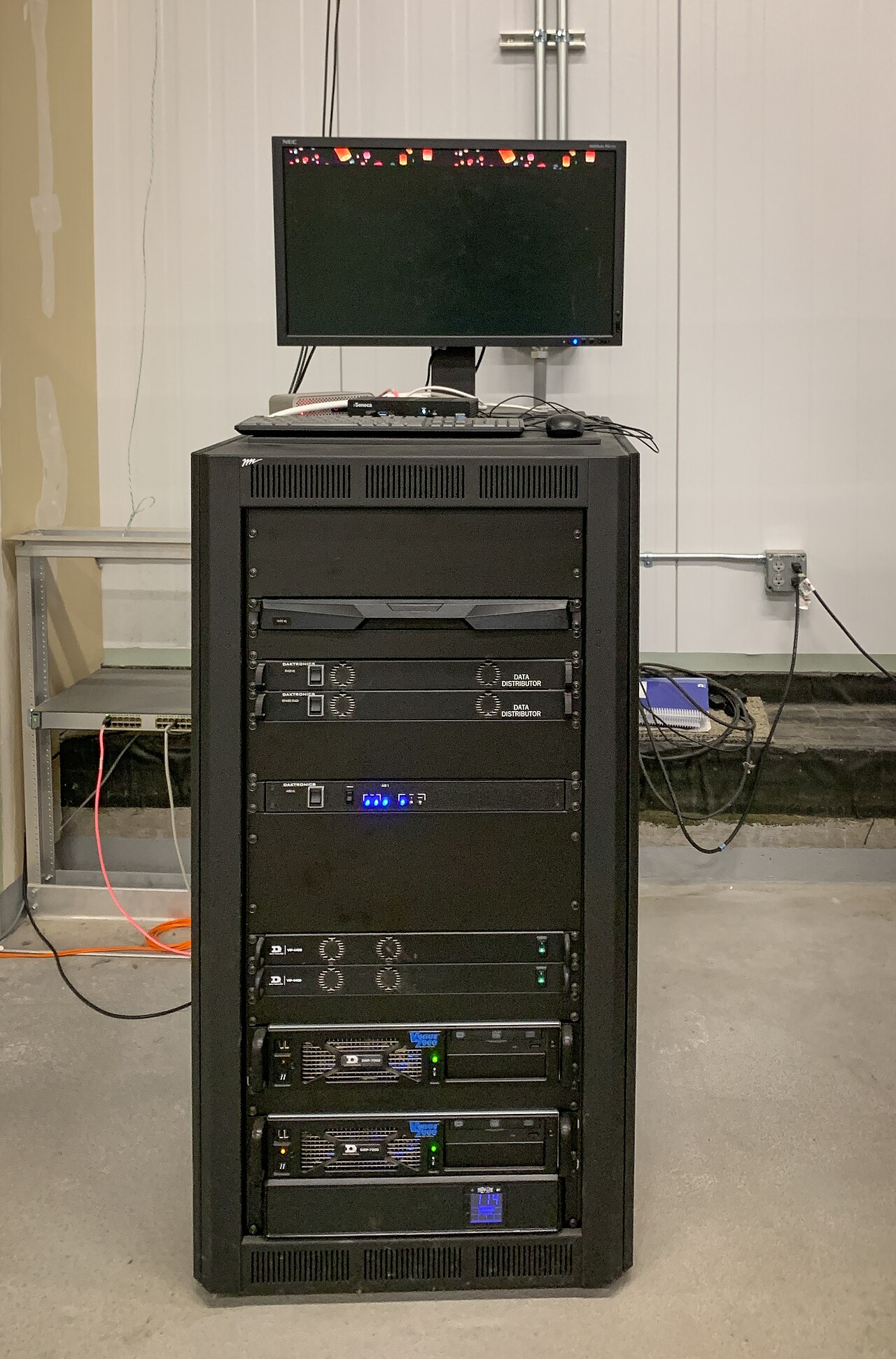 A dark server rack holding networking equipment, standing in for the remote storage that holds cloud items